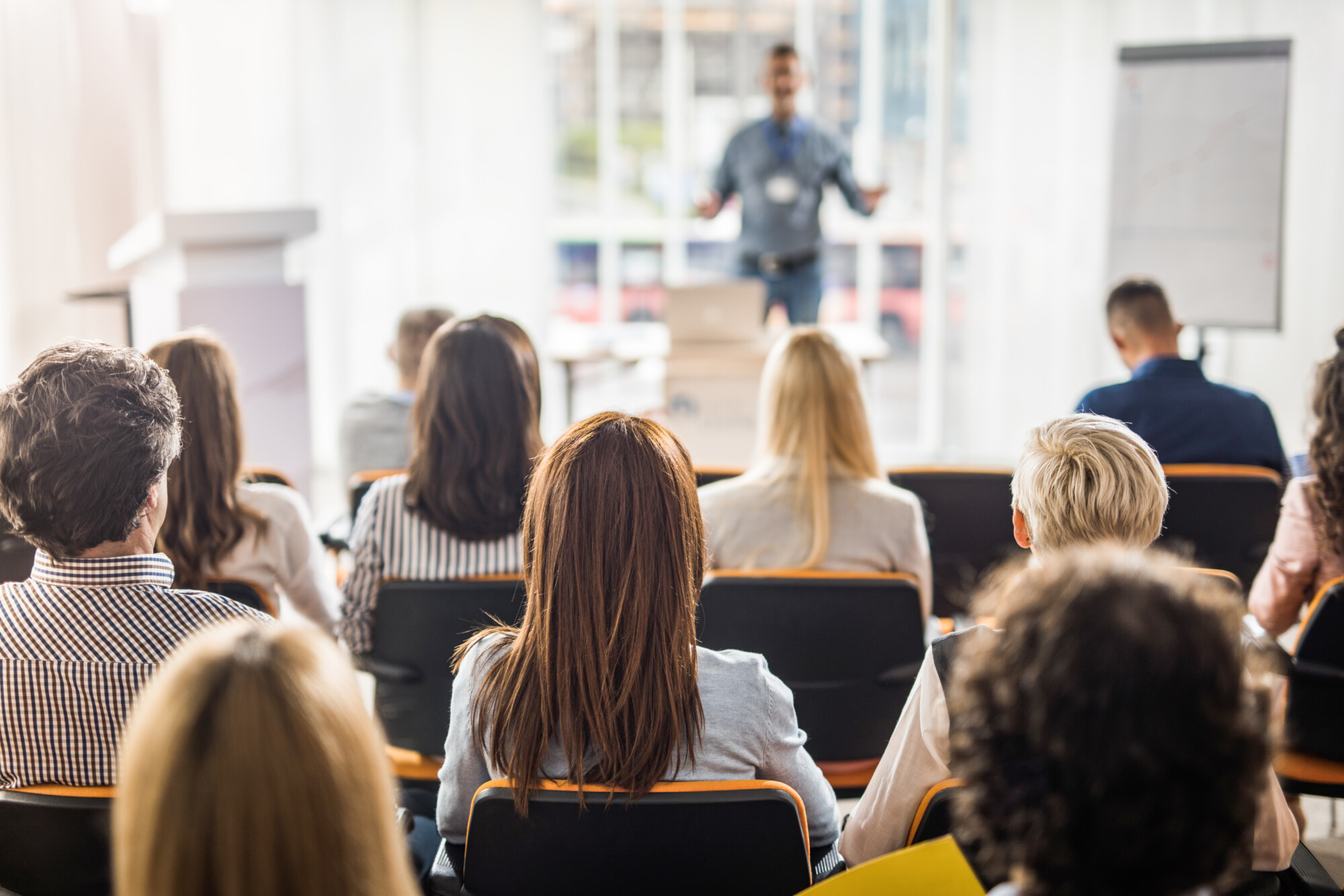 Back view of large group of business people having a training class in a board room