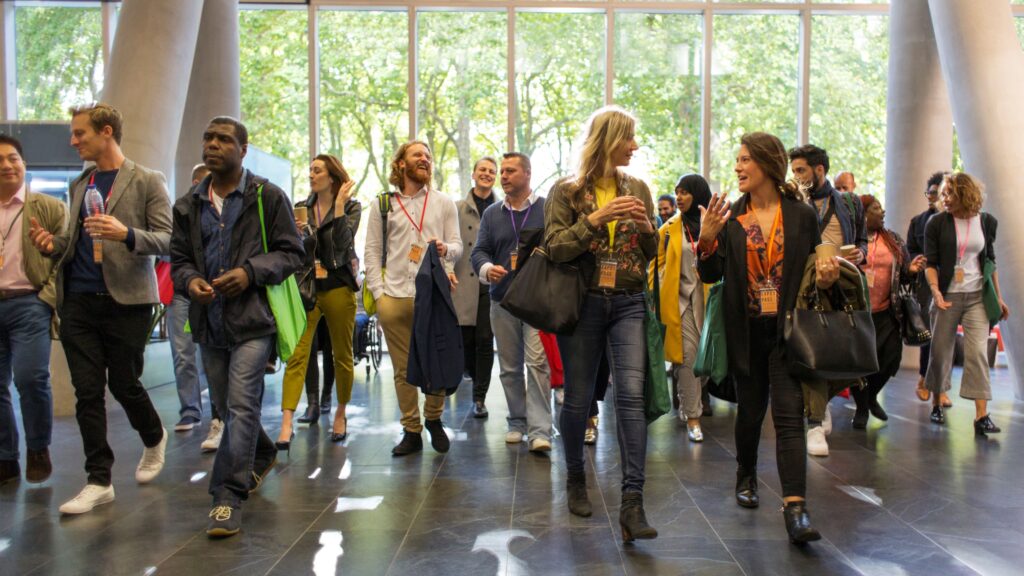 People entering the hall of a building to attend a conference